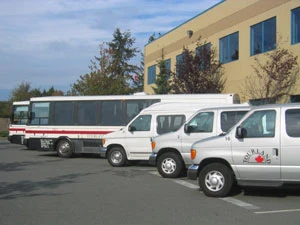 Transfer vans and a coach parked side by side