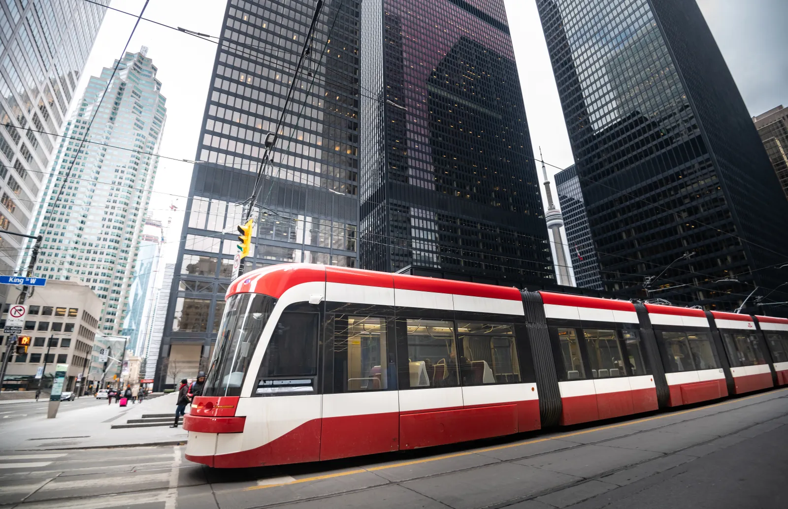 Streetcar running between office towers in downtown Toronto