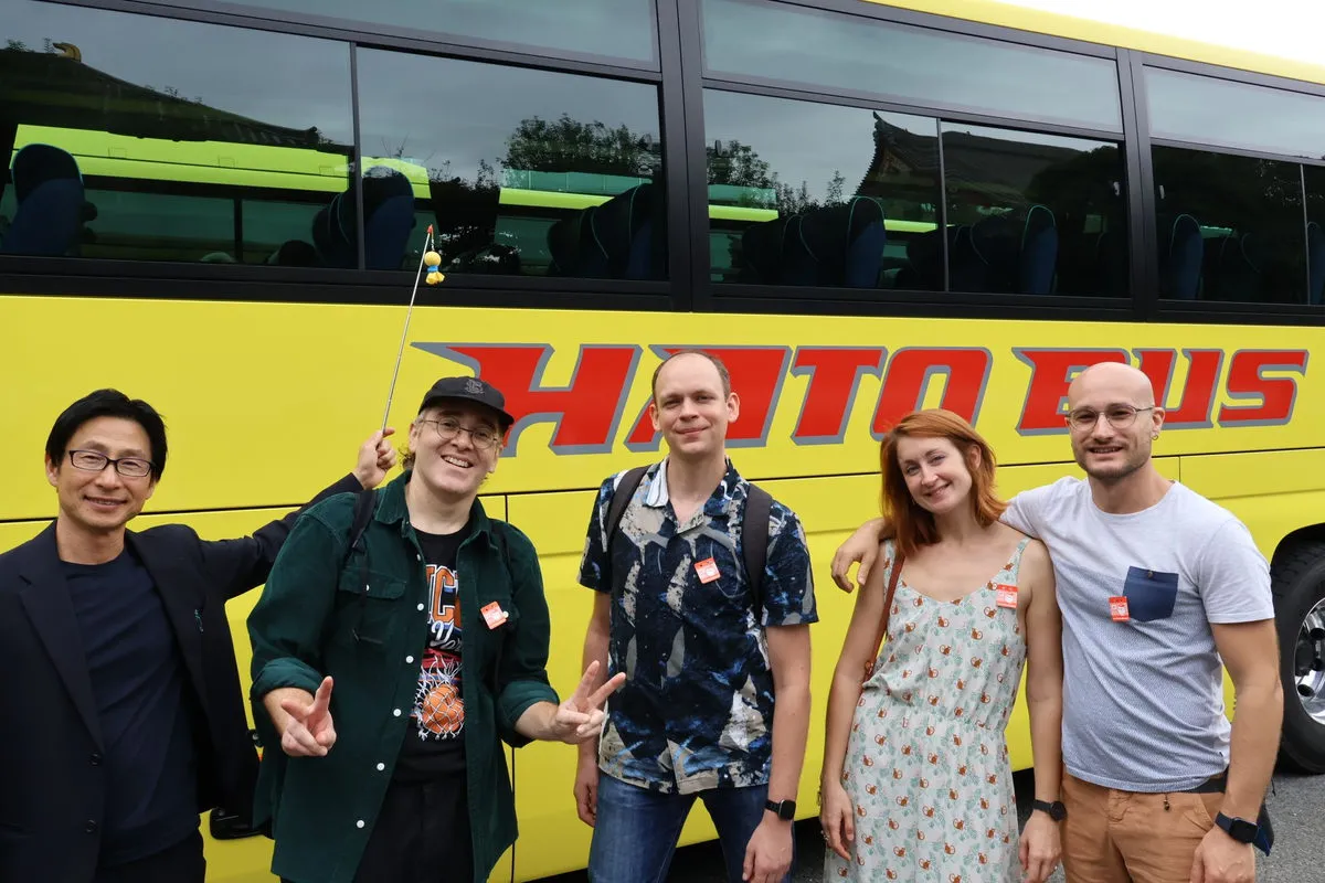 Tour guests smiling in front of a sightseeing bus