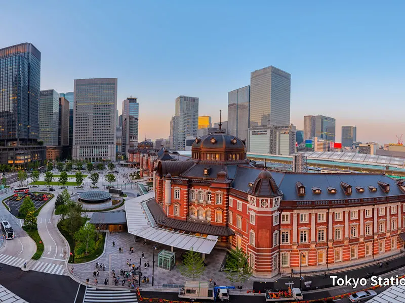 Tokyo Station Marunouchi building and plaza at dusk, with office towers behind