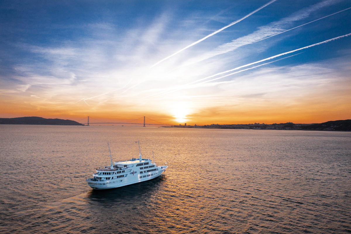 Cruise boat crossing the sea at sunset
